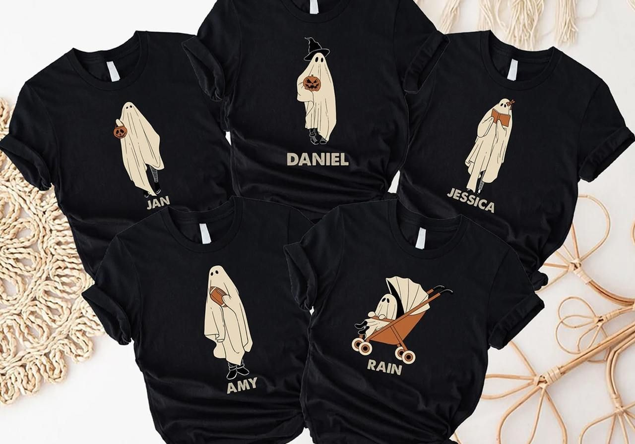 Five black t-shirts with cute ghost illustrations holding Halloween items for a family.